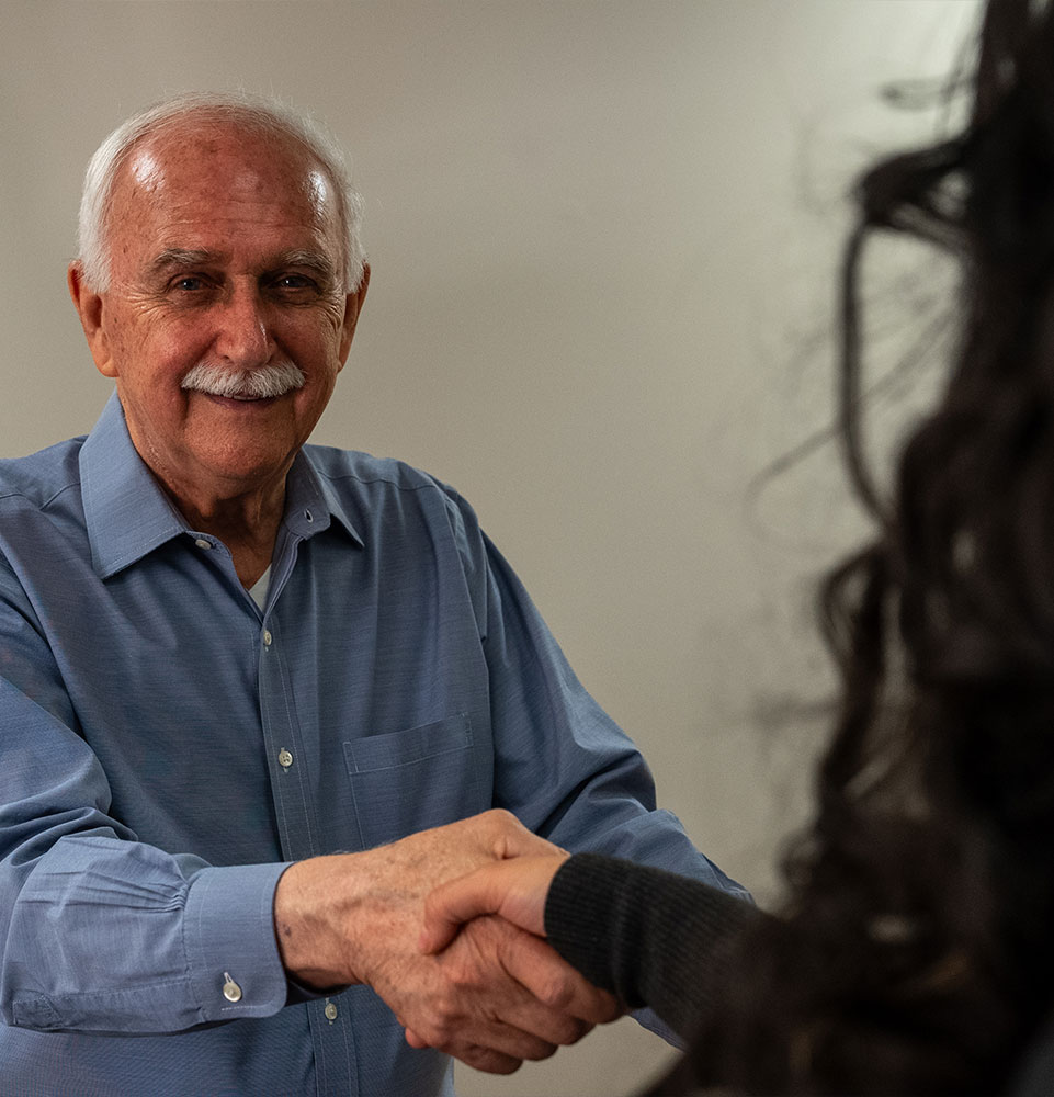 team member shaking patient hand