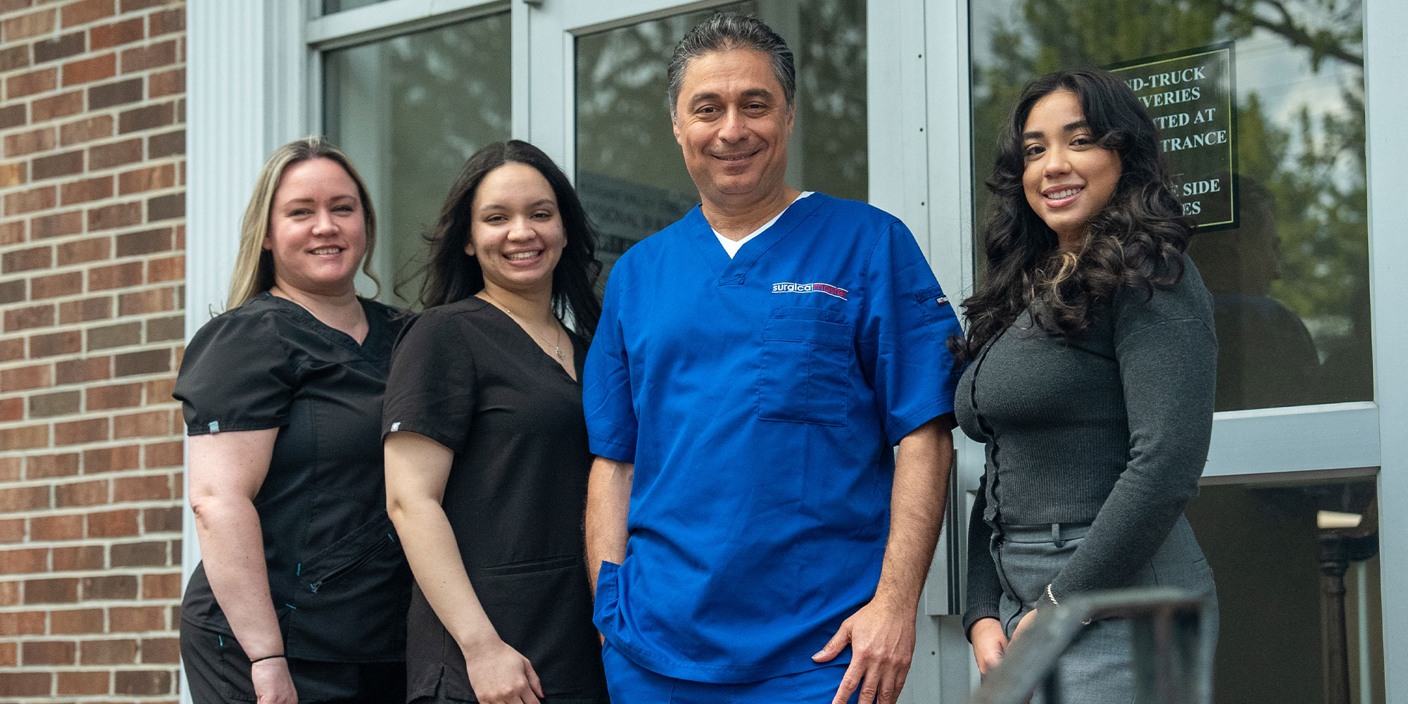 dentist and his team smiling