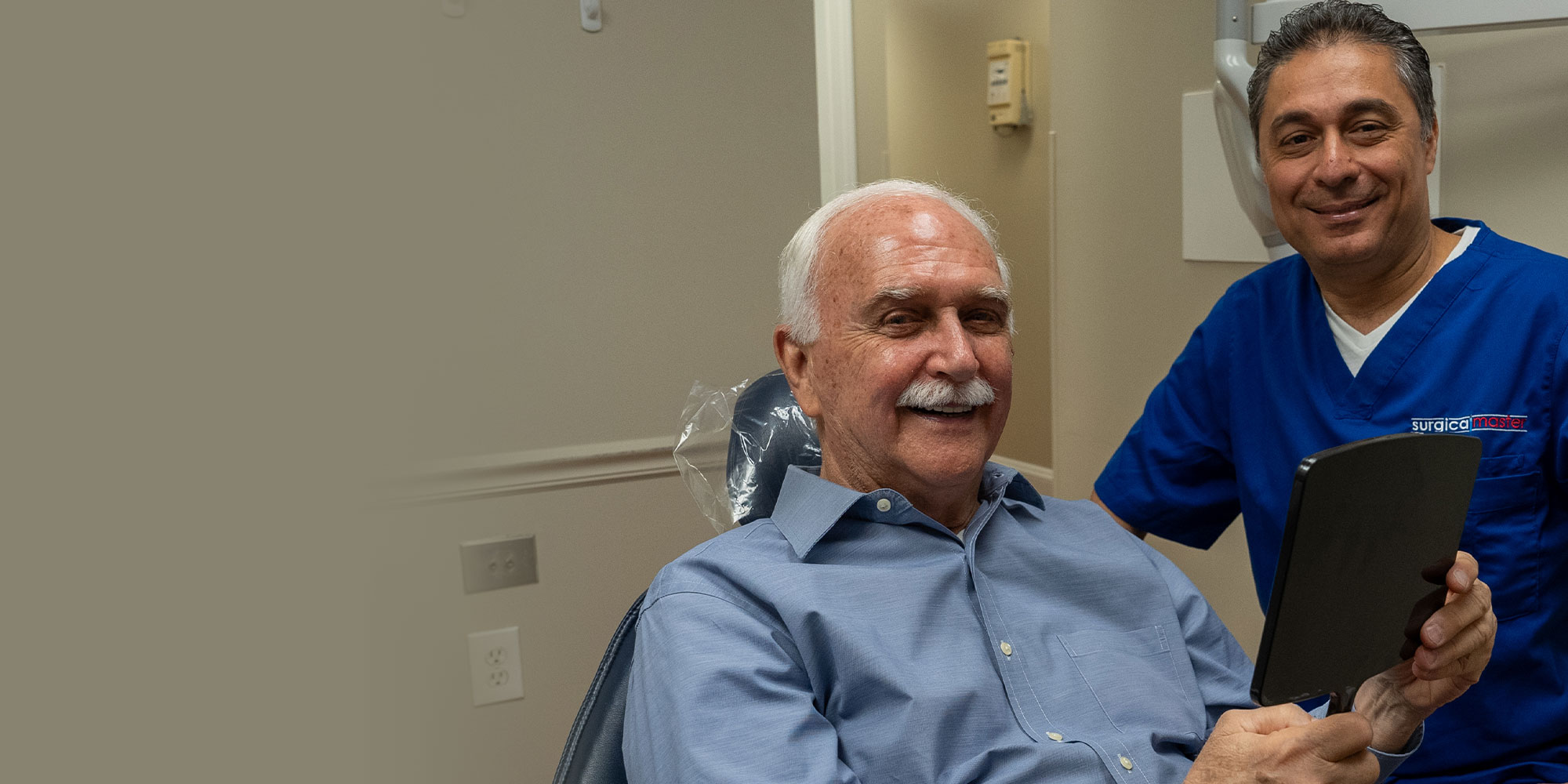 Dentist handing mirror to Patient