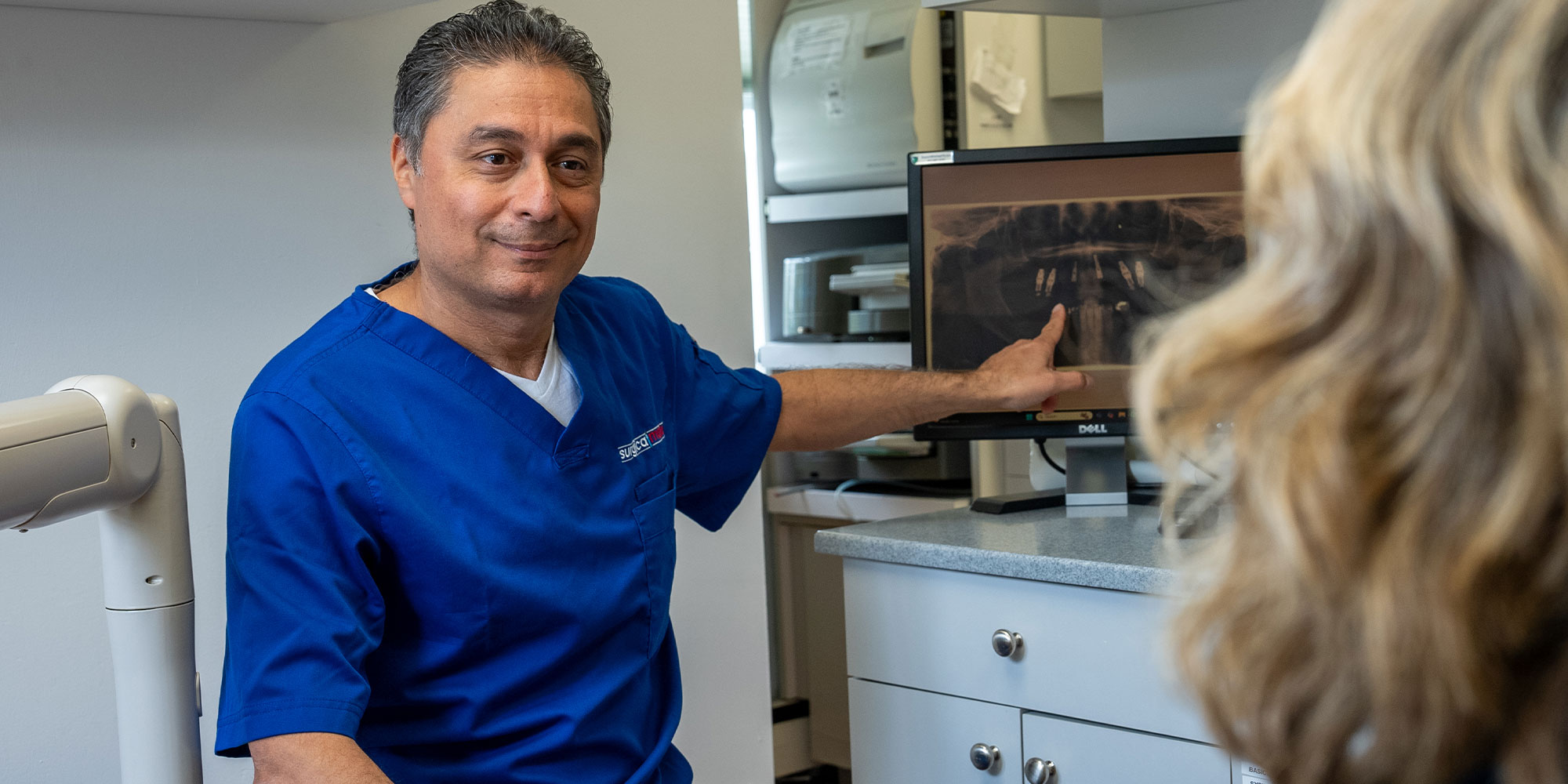 dentist going over dental x-rays with Patient