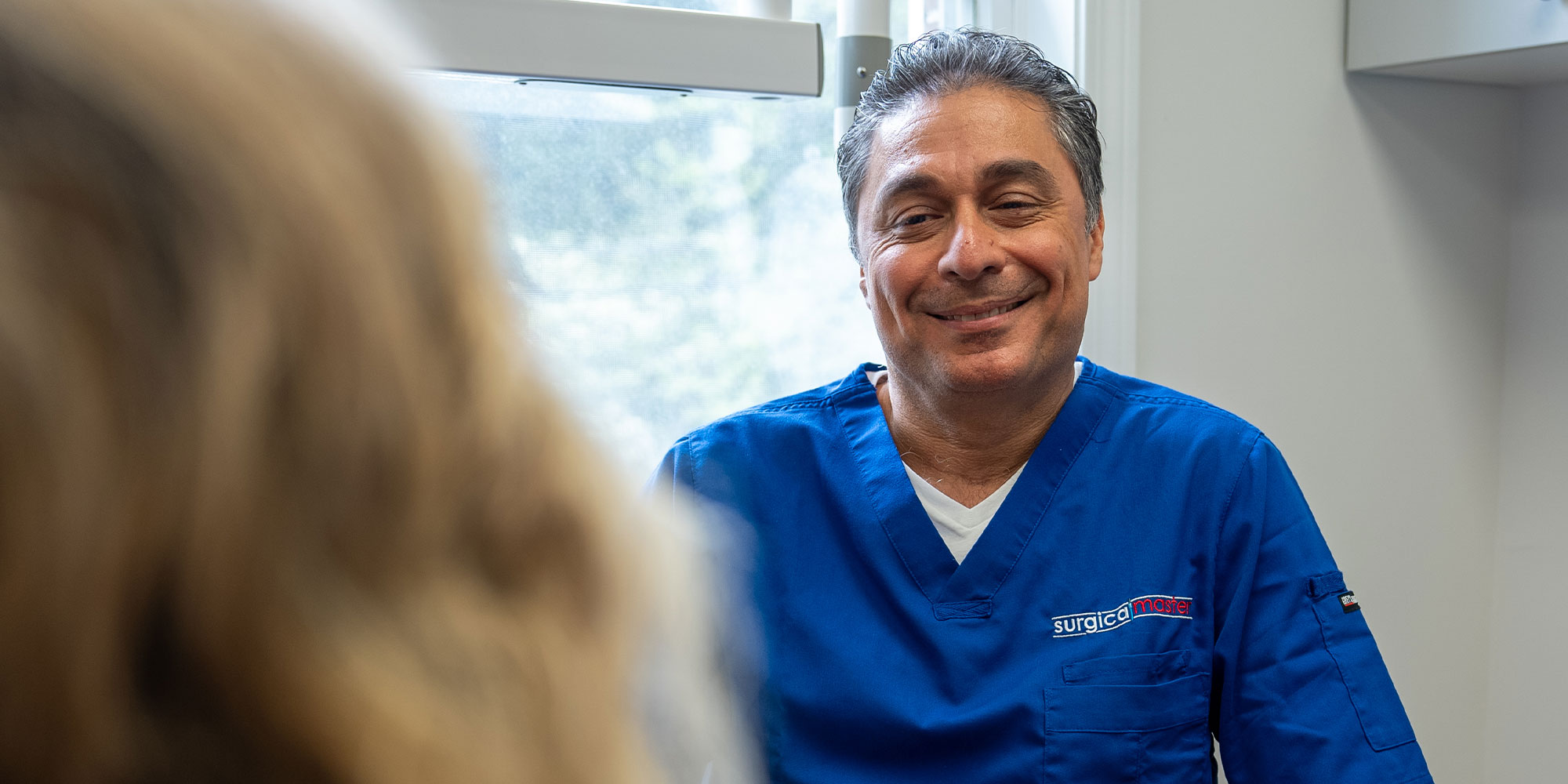 Dentist consulting with patient