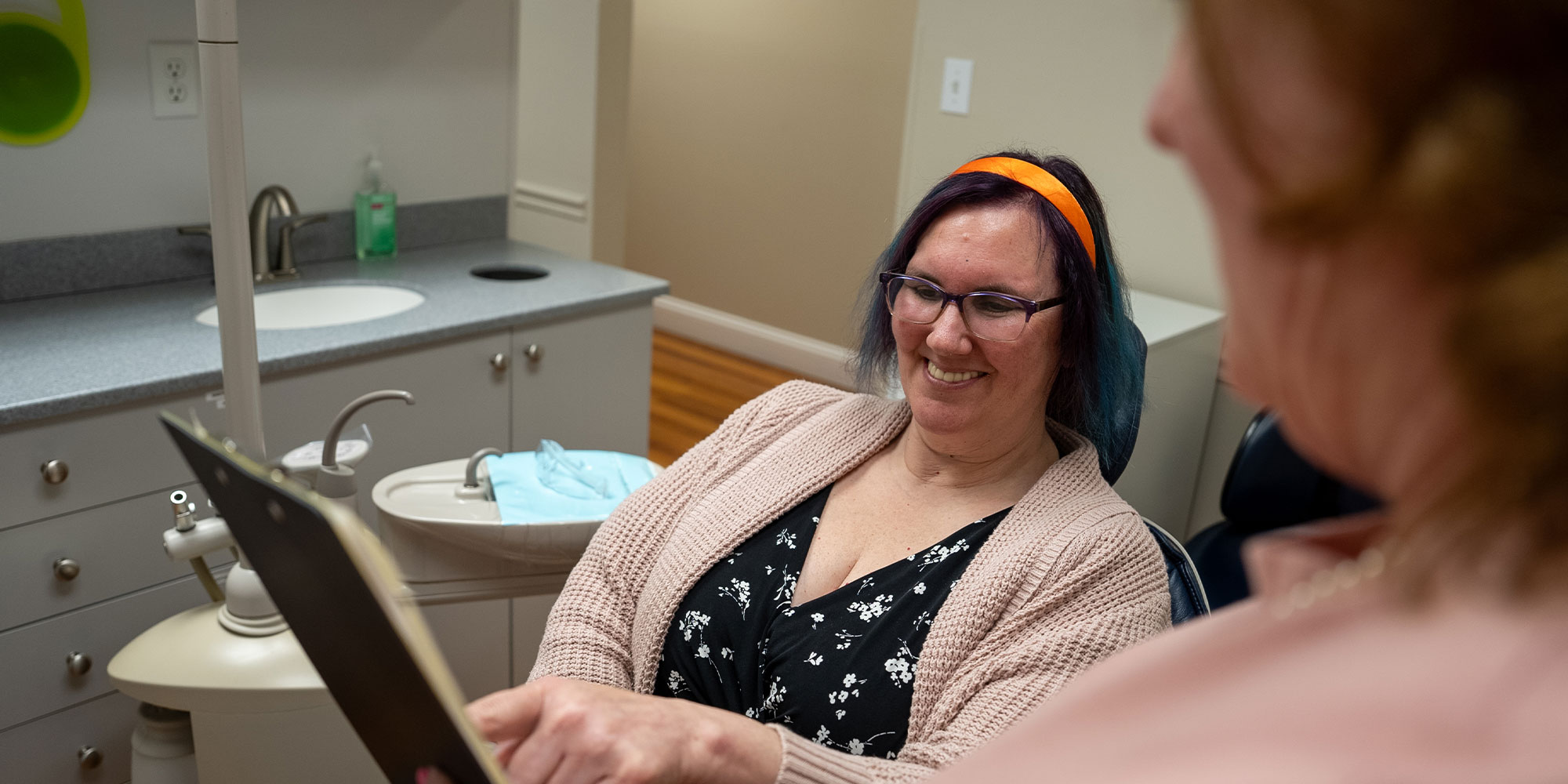 team member going over insurance forms with patient